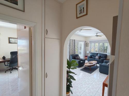 an archway leading into a living room with a couch at Villa Best Holiday- breathtaking sea views, amazing garden, private pool, BBQ, next to CORAL BAY, Lower Peyia, Paphos in Peyia
