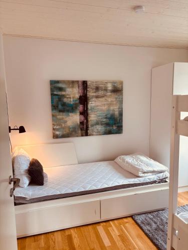 a bed in a room with a wall at Modern villa med spa och pool in Skäralid