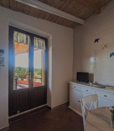 a kitchen with a door leading to a patio at Salina Holiday Home in Calasetta