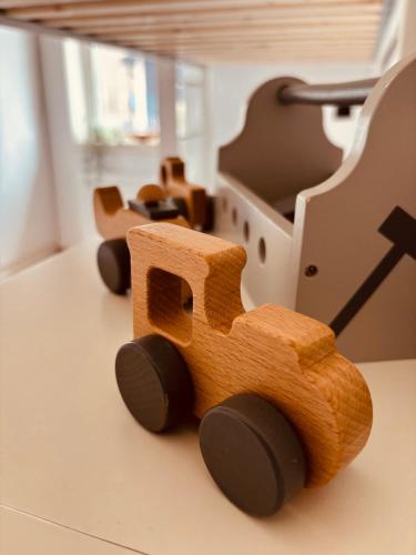 a wooden toy train sitting on top of a table at Modern villa med spa och pool in Skäralid