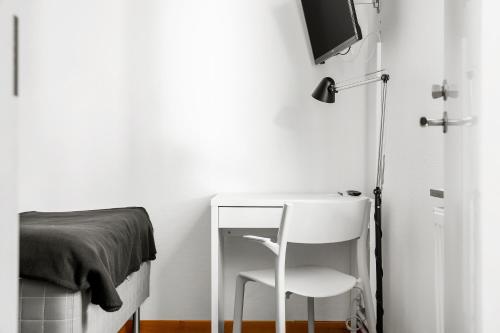 a bedroom with a white desk and a chair at Sure Hotel by Best Western Ojaby Herrgard in Växjö