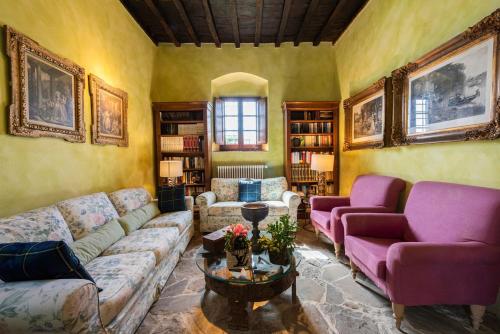 a living room with two couches and a table at Villa Riflessi di Fiesole - Piscina - Vista Firenze in Fiesole