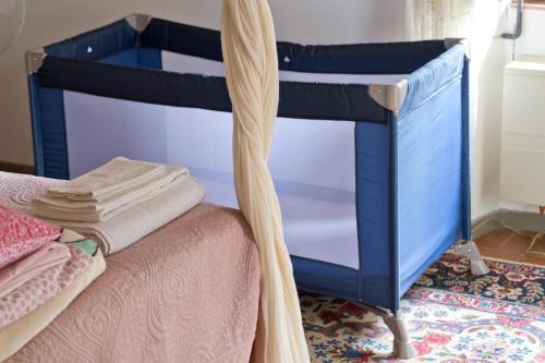 a blue bunk bed with a curtain next to it at Villa Riflessi di Fiesole - Piscina - Vista Firenze in Fiesole