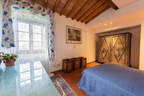 a bedroom with a bed and a window at Villa Riflessi di Fiesole - Piscina - Vista Firenze in Fiesole