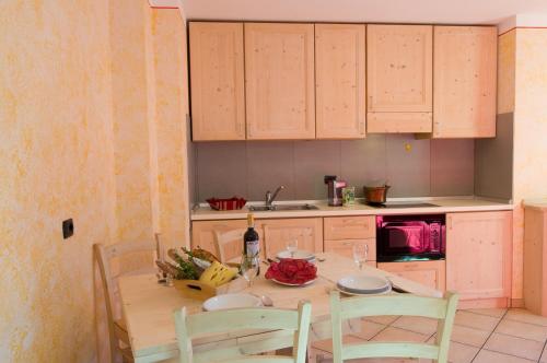 a kitchen with a table with a bunch of food on it at Chalet La Rugiada in Bormio