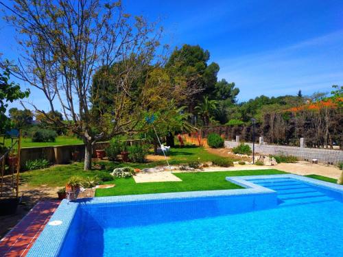 a swimming pool in a yard with a garden at Appartement Casita in Ontinyent