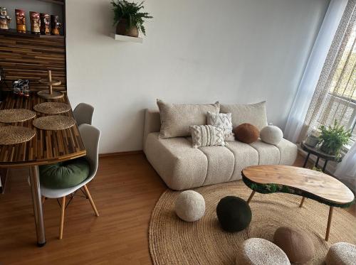 a living room with a couch and a table at Bali byt s parkovacím místem v centru města in České Budějovice