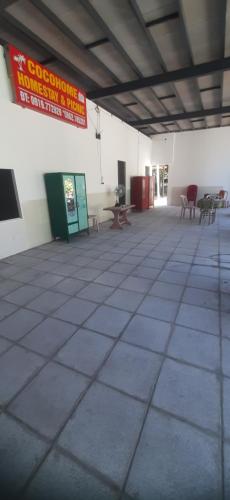an empty room with chairs and a sign on the wall at Vườn Dừa Cam Bình 1 in La Gi