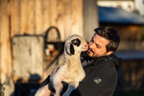 a man kissing a baby puppy at Wassererlehen in Bischofswiesen