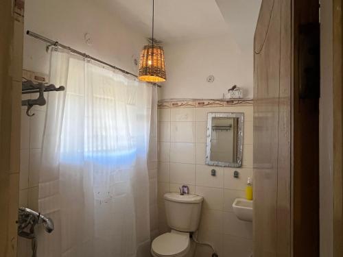 a bathroom with a toilet and a sink and a mirror at Area 369 in Jaipur