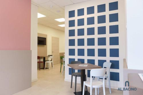 an office with a blue wall and a table and chairs at Double room with special accesses in a BB in Porto Viro in Porto Viro