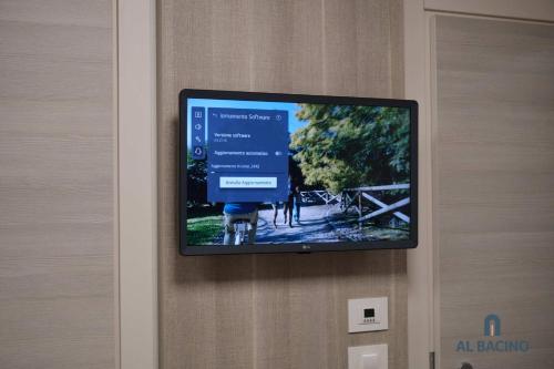 a flat screen tv hanging on a wall at Double room with special accesses in a BB in Porto Viro in Porto Viro