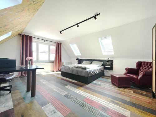 a bedroom with a bed and a desk and a couch at Das Melkmanns in Garding