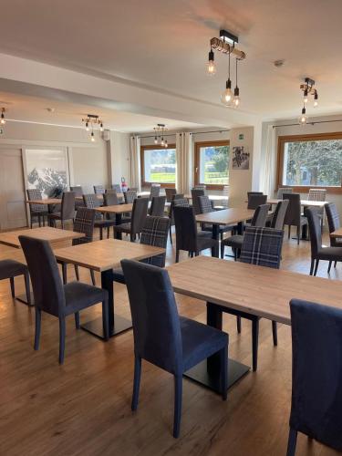 a dining room with wooden tables and chairs at Baita Fanti Ski & Bike in Bormio