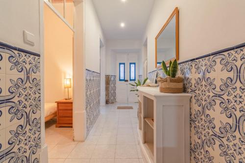 a hallway with blue and white walls and a bathroom at 4-bedroom Townhouse with Terrace in Center Oldtown in Lagos