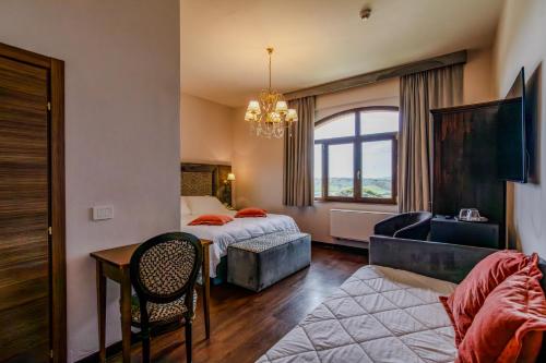 a hotel room with two beds and a couch at Villa Lecchi Hotel Wellness in Colle Val D'Elsa
