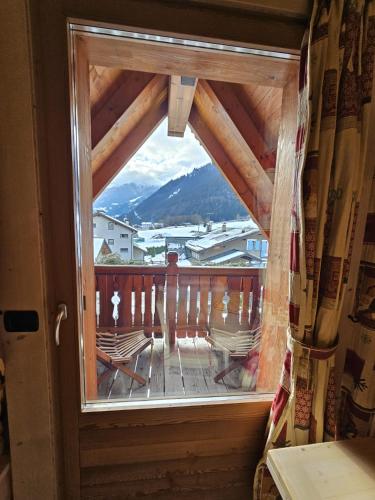 a window in a room with a view of a mountain at Chalet La Rugiada in Bormio