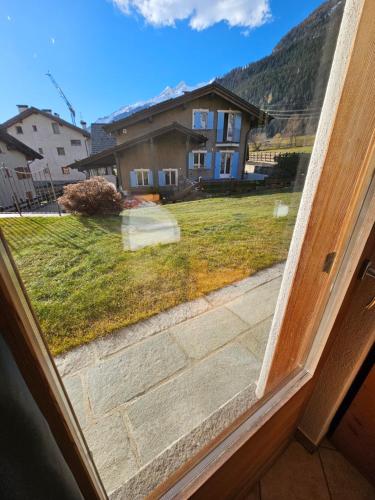a window view of a yard with a house at Chalet La Rugiada in Bormio