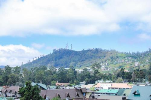 a view of a town with a mountain in the background at Premier Villa in Nuwara Eliya