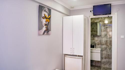 a bathroom with a white refrigerator and a sink at Grand Bona Sera Hotel in Istanbul