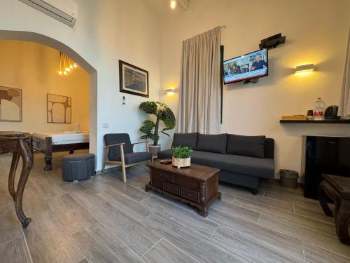a living room with a couch and a fireplace at Shirat Hayam Boutique Hotel in Tiberias