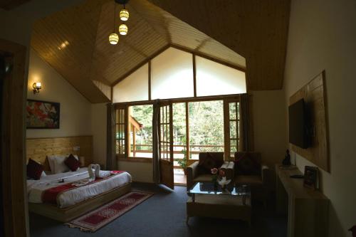 a bedroom with a bed and a couch in a room at Persimmon Farmstead in Manāli