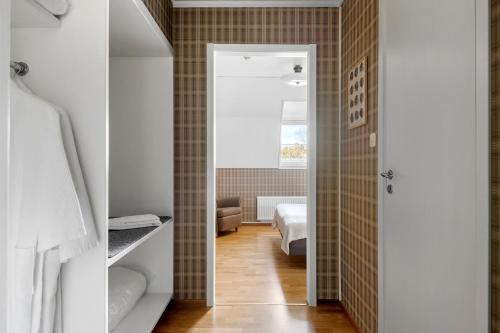 a room with a bedroom with a bed and a bathroom at Sure Hotel by Best Western Ojaby Herrgard in Växjö