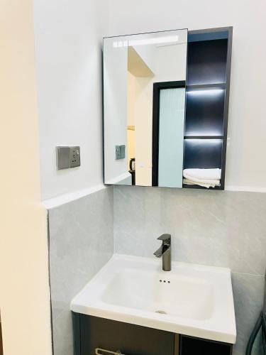 a bathroom with a sink and a mirror at Marina Bay Apartments Nairobi, Westlands in Nairobi