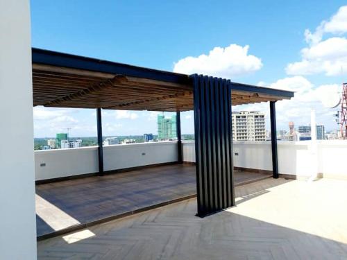a rooftop with awning on top of a building at Marina Bay Apartments Nairobi, Westlands in Nairobi