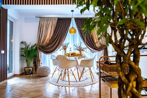 a dining room with a table and two chairs at Almi Aparthotel in Cluj-Napoca
