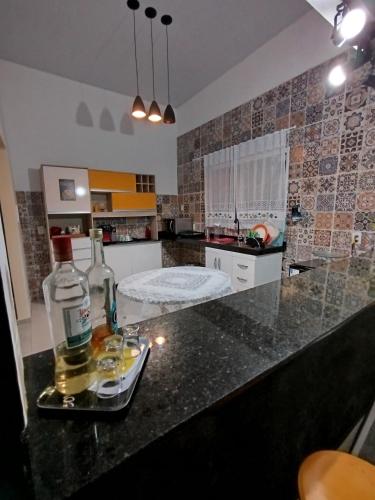 a kitchen counter with two bottles of alcohol on it at Spacious COP 30 home - Casa espaçosa COP 30 in Belém