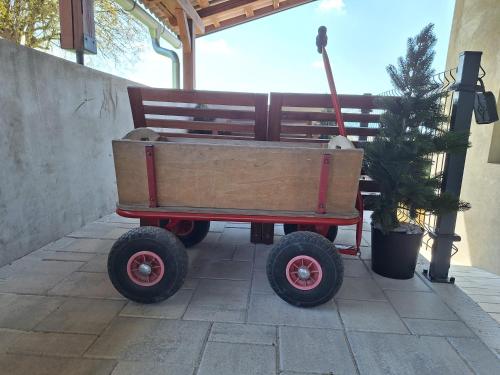 a wagon with wheels sitting next to a bench at Šipk -FREE-PARKING-BREAKFAST-TERRACE in Vojnik