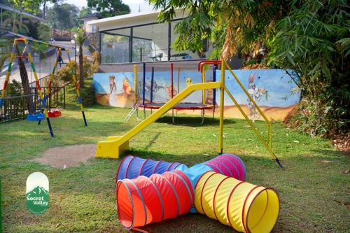 a playground with a slide in a park at Secret Valley Planation Resort in Munnar