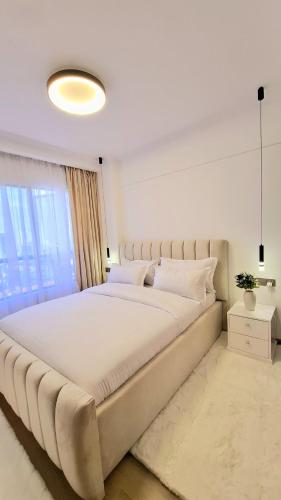 a large white bed in a room with a window at Marina Bay Apartments Nairobi, Westlands in Nairobi