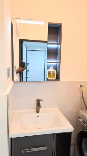 a bathroom with a sink and a mirror at Marina Bay Apartments Nairobi, Westlands in Nairobi