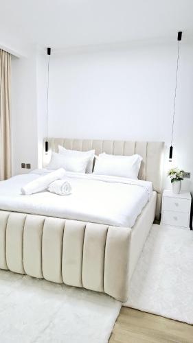 a white bedroom with a large white bed at Marina Bay Apartments Nairobi, Westlands in Nairobi