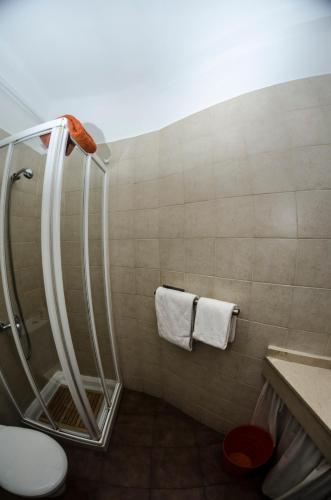 a bathroom with a shower with a toilet and towels at Blanca by gaiarooms in León