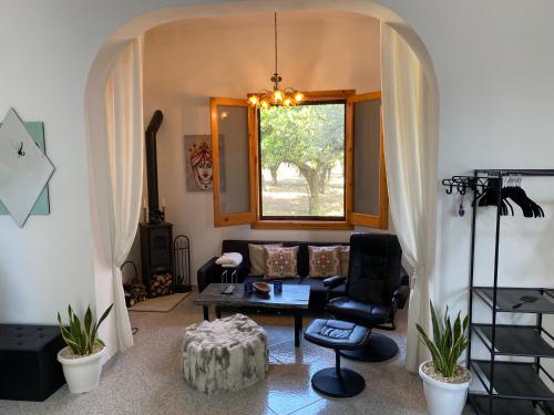 a living room with a couch and a window at Villa Medusa in Tre Fontane