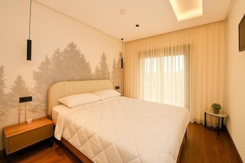 a bedroom with a large white bed and a window at Atelier Aedes - Studio 15 in Maarif