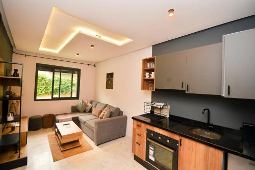 a kitchen and living room with a couch and a table at Atelier Aedes - Studio 2 in Maarif