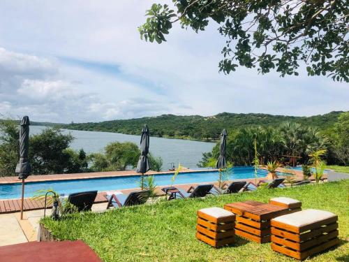 a swimming pool with a view of a body of water at Naara Eco Lodge & Spa in Chidenguele