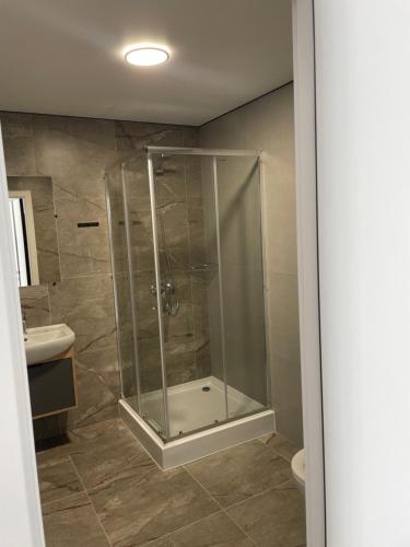 a bathroom with a shower and a sink at Hotel Hostel Перехрестя in Chistilov