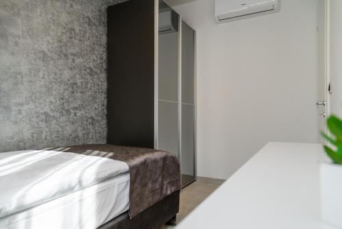 a bedroom with a bed and a glass door at Hotel - Teranea City Hvar in Hvar