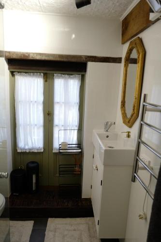 a bathroom with a sink and a window at Charming Historical Cottage in Bridgewater in Bridgewater