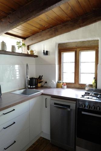 a kitchen with a sink and a stove at Charming Historical Cottage in Bridgewater in Bridgewater
