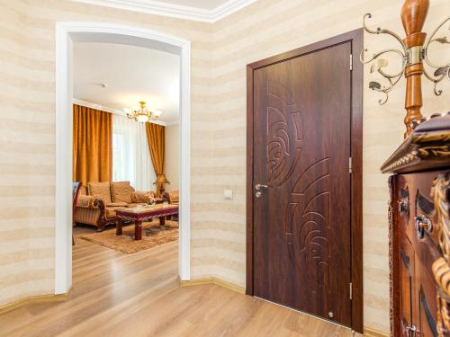 a room with a door and a living room with a couch at Hotel Park Suites Chisinau in Chişinău