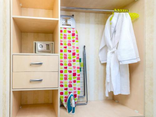 a small closet with a shower and a towel at Hotel Park Suites Chisinau in Chişinău