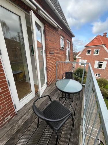 a patio with a table and chairs on a balcony at Entire apartment in lovely villa in Odense