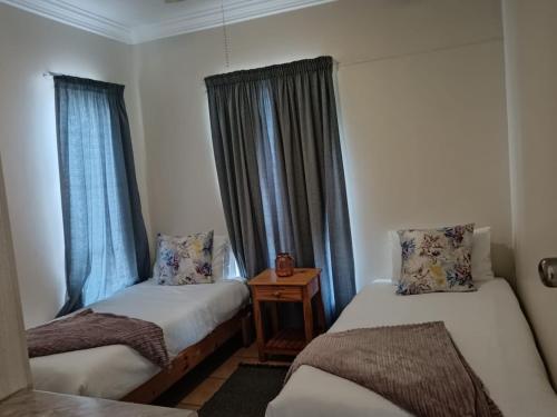 a room with two beds and a window at SANTANA 107 Margate in Margate