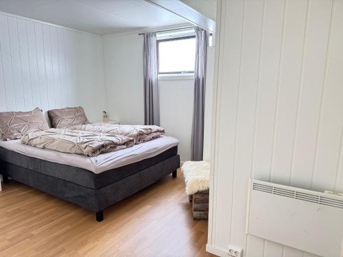 a bedroom with a bed and a window in it at beautiful apartment in nature in Oldervik